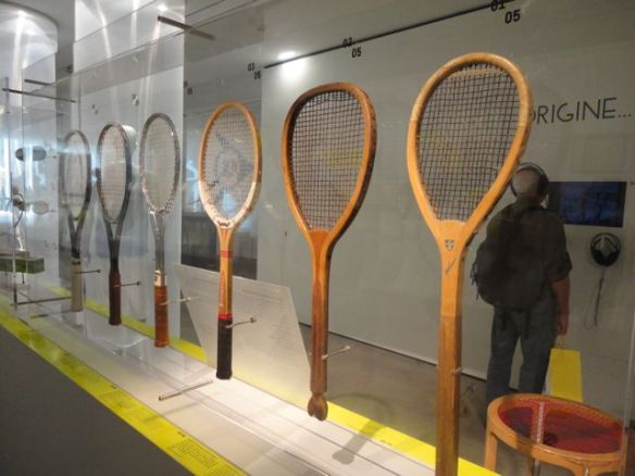 Evolution of tennis racquets.  The most current ones are made of graphite or carbon fiber.